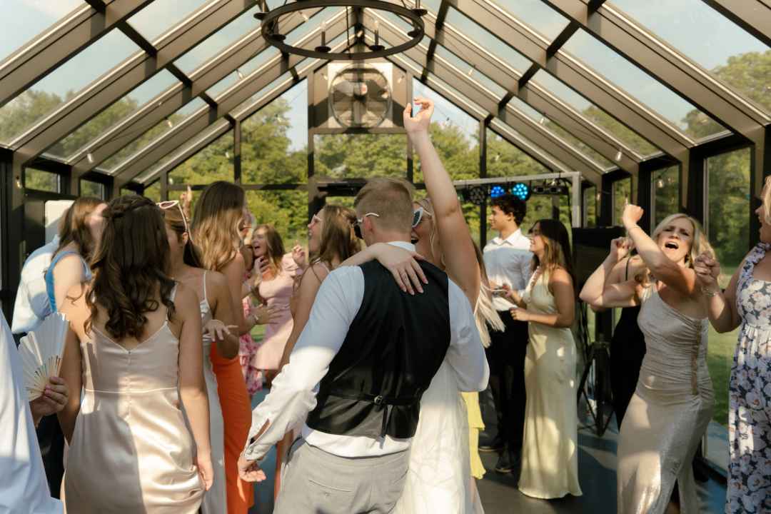 A newly wed couple dancing with family.