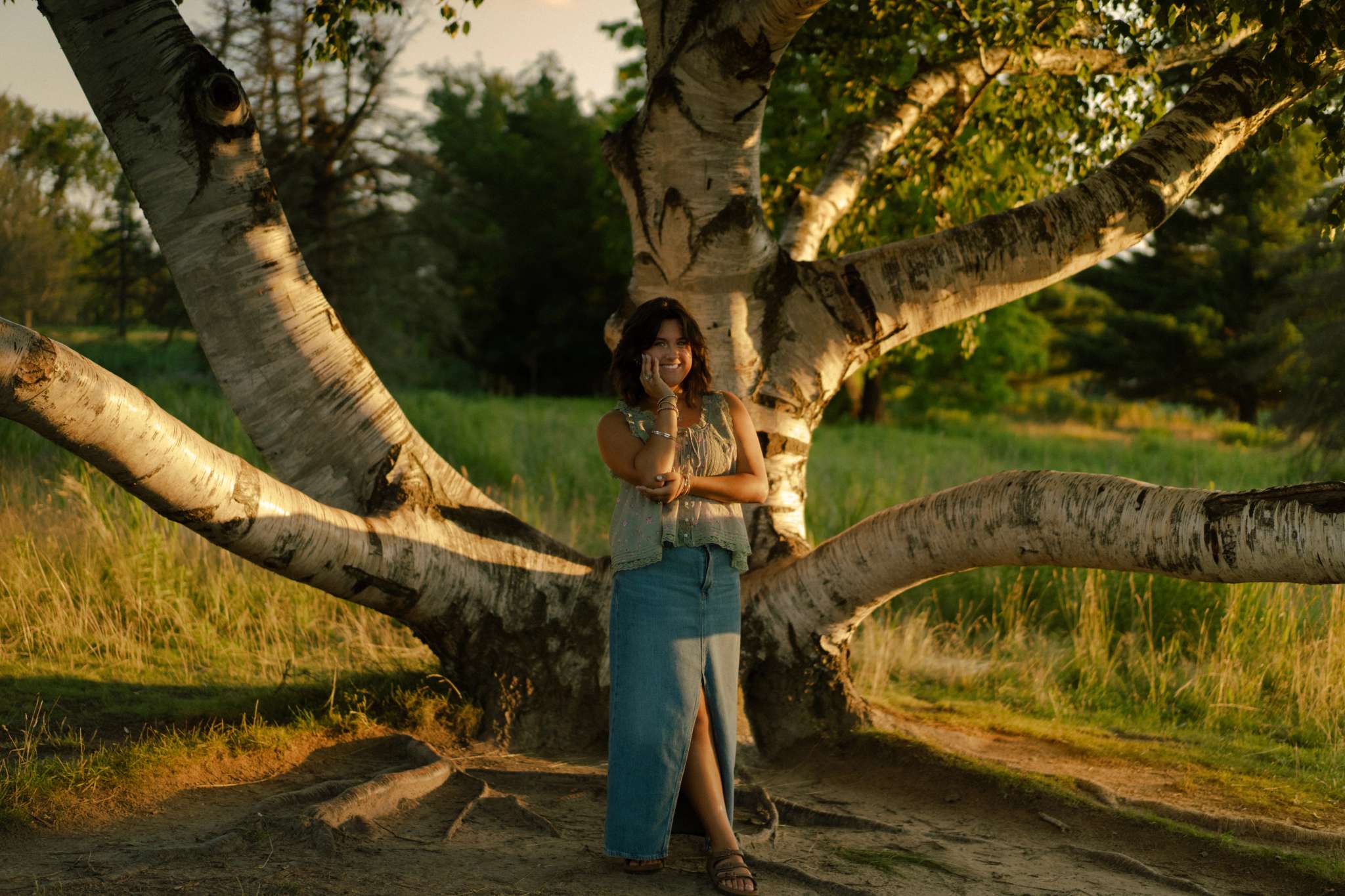 Senior photo session by an aesthetic tree.